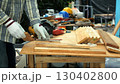 Carpenter measuring wooden plank with ruler on workbench surrounded by tools and safety equipment 130402800