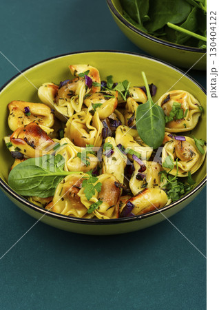 Cooked spinach dumplings in bowl. 130404122