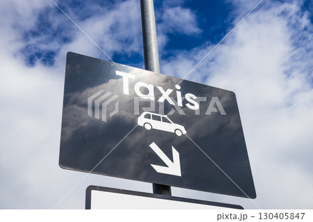 Taxi Rank Direction Sign with Arrow Against Blue Sky, Urban Transport Wayfinding Taxi Rank Direction Sign with Arrow Against Blue Sky, Urban Transport Wayfinding 130405847