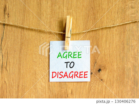 Agree to disagree symbol. Concept words Agree to disagree on beautiful white paper on wooden clothespin. Beautiful wooden background. Business and agree to disagree concept. Copy space. 130406276
