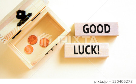 Good luck symbol. Concept words Good luck on beautiful wooden block. Beautiful white table white background. Wooden chest with coins. Business, motivational good luck concept. Copy space. Good luck symbol. Concept words Good luck on beautiful wooden block. Beautiful white table white background. Wooden chest with coins. Business, motivational good luck concept. Copy space. 130406278