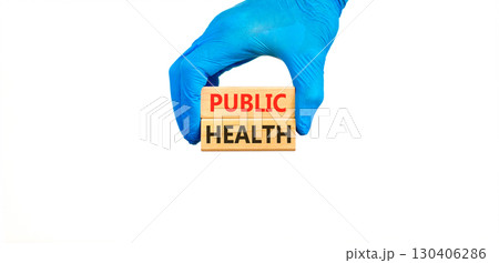 Public health symbol. Concept words Public health on beautiful wooden blocks. Doctor's hand in blue medical glove. Beautiful white background. Medical healthy lifestyle public health concept. Public health symbol. Concept words Public health on beautiful wooden blocks. Doctor's hand in blue medical glove. Beautiful white background. Medical healthy lifestyle public health concept. 130406286