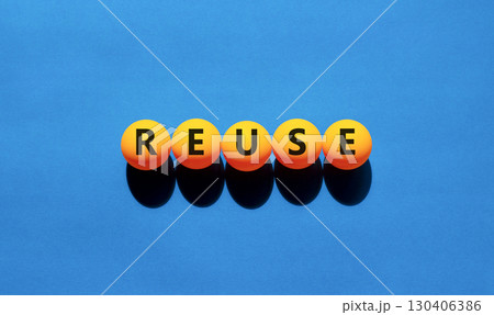 Reuse symbol. Concept word Reuse on beautiful yellow tennis ping pong balls. Beautiful wooden table wooden background. Business lifestyle ecological reuse concept. Copy space. Reuse symbol. Concept word Reuse on beautiful yellow tennis ping pong balls. Beautiful wooden table wooden background. Business lifestyle ecological reuse concept. Copy space. 130406386