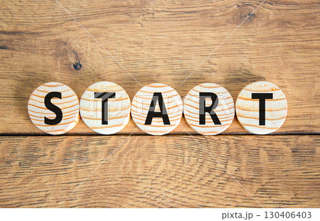 Start symbol. Concept word Start on beautiful wooden circles. Beautiful wooden table wooden background. Business lifestyle start concept. Copy space. Start symbol. Concept word Start on beautiful wooden circles. Beautiful wooden table wooden background. Business lifestyle start concept. Copy space. 130406403