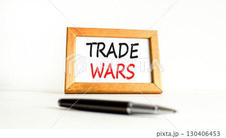 Trade wars symbol. Concept word Trade wars on beautiful wooden picture frame. Black pen. Beautiful white paper background. Business trade wars concept. Copy space. 130406453