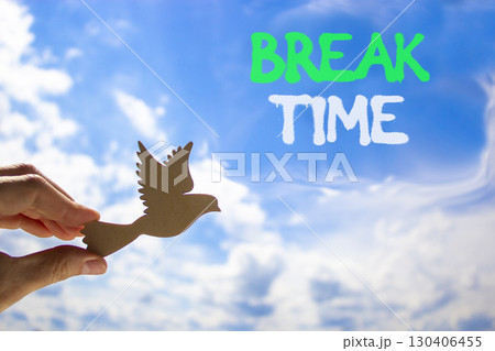 Break time symbol. Concept word Break time on beautiful blue sky. Businessman's hand with wooden bird. Beautiful blue sky and cloud background. Business break time concept. Copy space. Break time symbol. Concept word Break time on beautiful blue sky. Businessman's hand with wooden bird. Beautiful blue sky and cloud background. Business break time concept. Copy space. 130406455