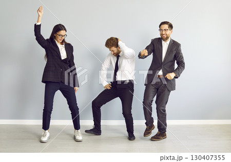 Team of happy, funny, cheerful business people dancing and having fun at office party 130407355
