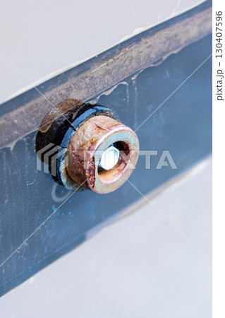 Close-up of Rusty Mechanical Part on Metal Surface 130407596