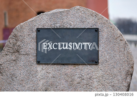 Equity, diversity, EXCLUSIVITY concept. Copy space. EXCLUSIVITY word written on the plaque of a large stone monument. 130408016