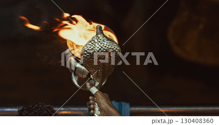 Varanasi, Uttar Pradesh, India. Candle Holder With Lit Candles On Ganga Maha Aarti Ceremony Begins. Fire Puja Ritual In Varanasi. Traditional Ganga Aarti At Ghat Varanasi, Uttar Pradesh, India. Candle Holder With Lit Candles On Ganga Maha Aarti Ceremony Begins. Fire Puja Ritual In Varanasi. Traditional Ganga Aarti At Ghat 130408360