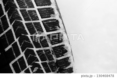 Winter Studless Car Tire In A Deep Untouched Snow Top View Closeup Stock Photo Winter Studless Car Tire In A Deep Untouched Snow Top View Closeup Stock Photo 130408478