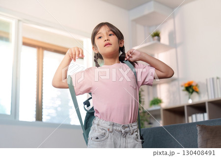 Child wearing backpack, ready for school 130408491
