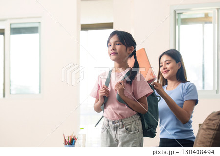 Child getting ready for school with mother help 130408494
