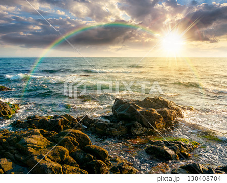 sea coast with rocks and boulders at sunset. calm summer vacation background at the seashore. wonderful scene for relax and leisure at the seaside in evening light sea coast with rocks and boulders at sunset. calm summer vacation background at the seashore. wonderful scene for relax and leisure at the seaside in evening light 130408704
