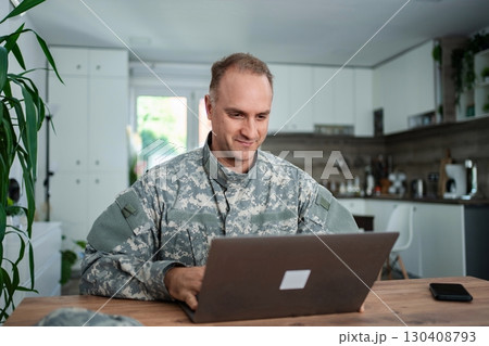 American Soldier Working From Home on Laptop 130408793