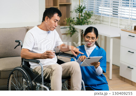 Helpful volunteers caring for elderly men at home health care. 130409255