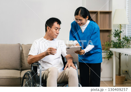 Helpful volunteers caring for elderly men at home health care. 130409257