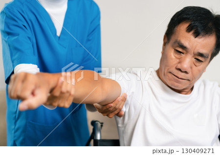 senior man doing exercise at clinic with physiotherapist. help of a personal trainer during a rehabilitation session. senior man doing exercise at clinic with physiotherapist. help of a personal trainer during a rehabilitation session. 130409271