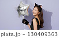 ハロウィンの猫コスプレの若い女性が笑顔でポーズを決める 130409363