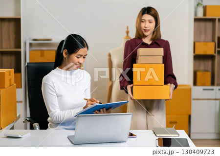 Small business entrepreneur SME freelance woman working at home office, boxs ,tablet and laptop online, marketing, packaging, delivery, e-commerce concept. Small business entrepreneur SME freelance woman working at home office, boxs ,tablet and laptop online, marketing, packaging, delivery, e-commerce concept. 130409723