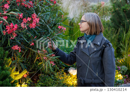 Exploring a vibrant garden at dusk with blooming flowers and lush greenery Exploring a vibrant garden at dusk with blooming flowers and lush greenery 130410214