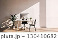 Cozy Home Office with Laptop, Notepad, and Plant in Sunlit Room 130410682