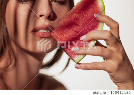 Woman face with watermelon slice against skin freshness 130411186