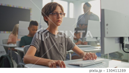 Smart Young Boy Using Computer, Learning Coding During Digital Programming Lesson 130411289