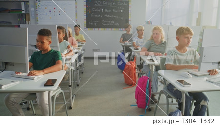 Primary School Students Working on Creative Projects on Computers 130411332