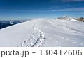 Snow-covered ridge at the summit of Piz Palu offers breathtaking views of the Bernina range in summer. Footprints reveal the adventurous hike up this stunning alpine peak. 130412606