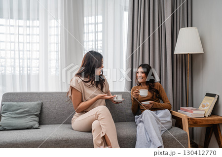 Relaxing Moments Friends Enjoying Coffee in a Cozy and Inviting Living Room Relaxing Moments Friends Enjoying Coffee in a Cozy and Inviting Living Room 130412770