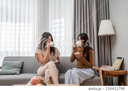 Enjoying a delightful Tea and engaging Conversation Friends Bonding at Home Enjoying a delightful Tea and engaging Conversation Friends Bonding at Home 130412798