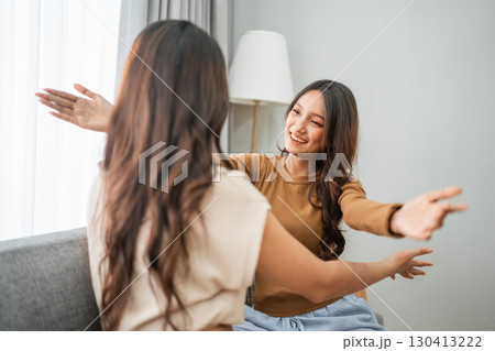 Joyful Friends Happily Embracing Each Other in a Cozy Indoor Environment 130413222