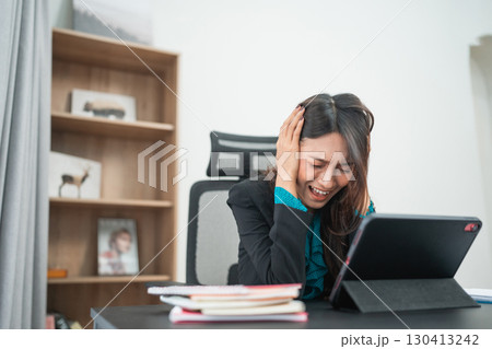 A Stressed Businesswoman in Her Home Office Struggling with Technology and Setup A Stressed Businesswoman in Her Home Office Struggling with Technology and Setup 130413242