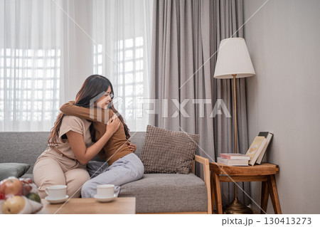Emotional Embrace Friends Sharing Comfort, Joy, and Support Together at Home 130413273