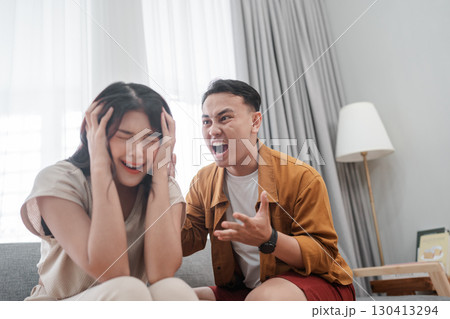 A Frustrated Argument Between Young Friends is Taking Place in a Cozy Living Room 130413294
