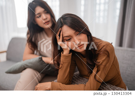 Women Sharing Vulnerability and Emotional Support in a Cozy Living Room Women Sharing Vulnerability and Emotional Support in a Cozy Living Room 130413304