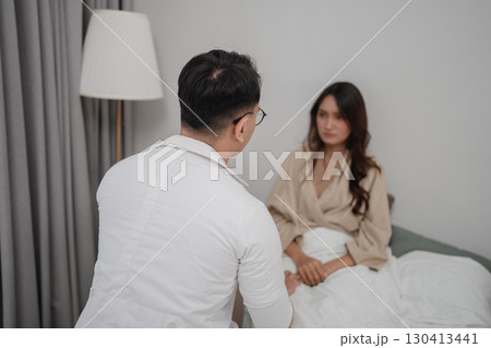 Consultation Session Between Doctor and Patient in Modern Bedroom Setting 130413441