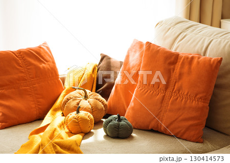 Autumnal living room decor with corduroy pumpkins and cozy pillows. Autumnal living room decor with corduroy pumpkins and cozy pillows. 130414573