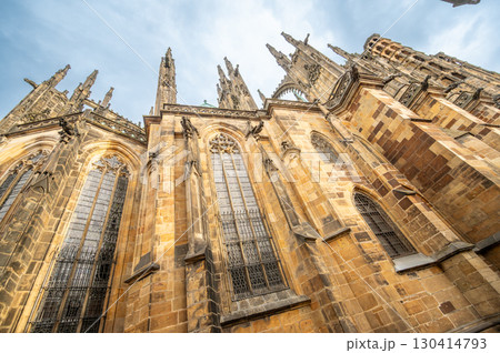 Prague, Czech Republic, August 6, 2023. Side view of St. Vitus Cathedral on a rainy day, detail of the gargoyles and spires. Travel destinations. 130414793