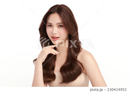 A beautiful young Asian woman with clean, fresh skin against a white background. Skincare, facial treatment, cosmetology, beauty, and spa. An elegant portrait of an Asian woman. 130414952