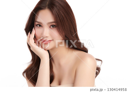 A beautiful young Asian woman with clean, fresh skin against a white background. Skincare, facial treatment, cosmetology, beauty, and spa. An elegant portrait of an Asian woman. 130414958