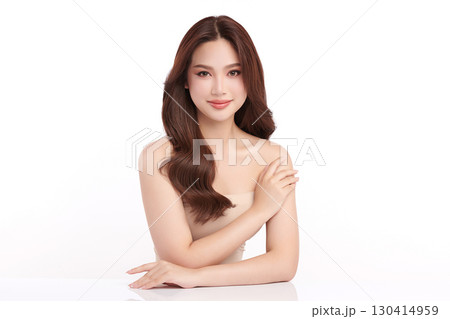 A beautiful young Asian woman with clean, fresh skin against a white background. Skincare, facial treatment, cosmetology, beauty, and spa. An elegant portrait of an Asian woman. 130414959