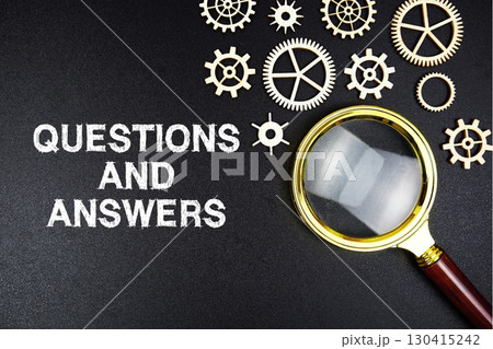 Questions and Answers text message with magnifying glass on black background 130415242