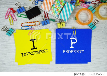 IP - Investment Property text on stick note with stationery on concrete background IP - Investment Property text on stick note with stationery on concrete background 130415272