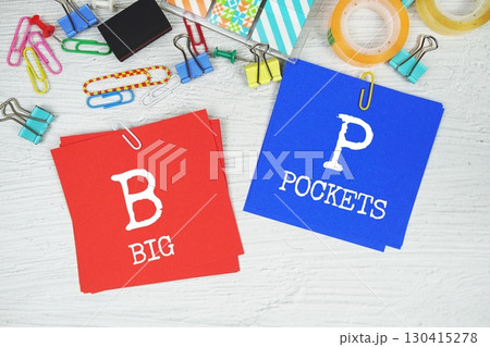 BP - Big Pockets text on stick note with stationery on concrete background BP - Big Pockets text on stick note with stationery on concrete background 130415278