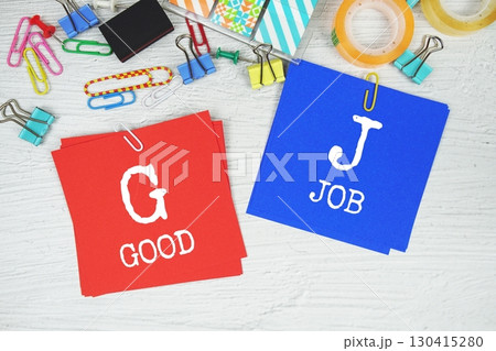 GB - Good Job text on stick note with stationery on concrete background GB - Good Job text on stick note with stationery on concrete background 130415280
