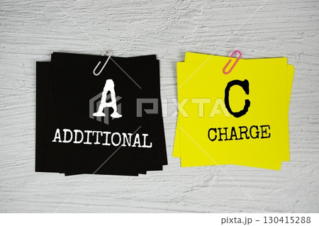 AC - Additional Charge text message on stick note on concrete background 130415288
