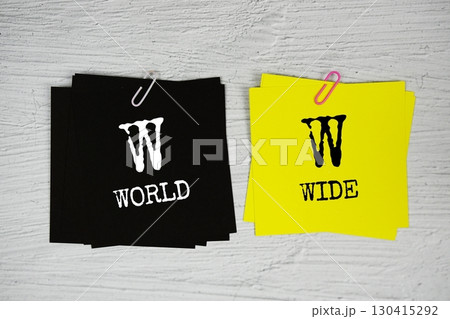 WW - World Wide text on stick note on concrete background WW - World Wide text on stick note on concrete background 130415292