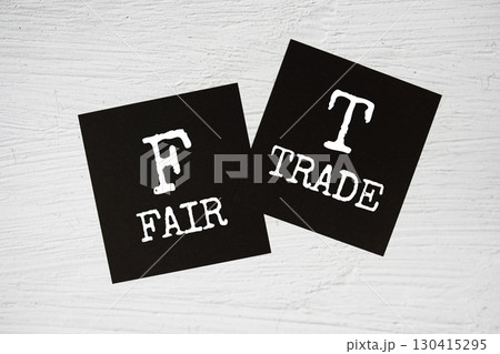 FT - Fair Trade text on stick note on concrete background FT - Fair Trade text on stick note on concrete background 130415295